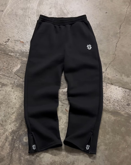 Pantalón de chándal con cremallera de color liso